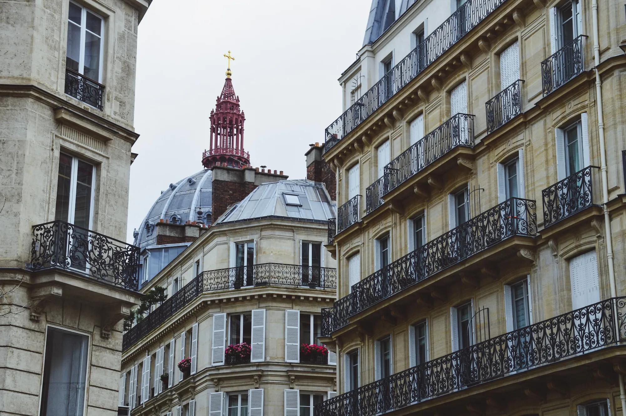 Classic Parisian Haussmann buildings with wrought-iron balconies